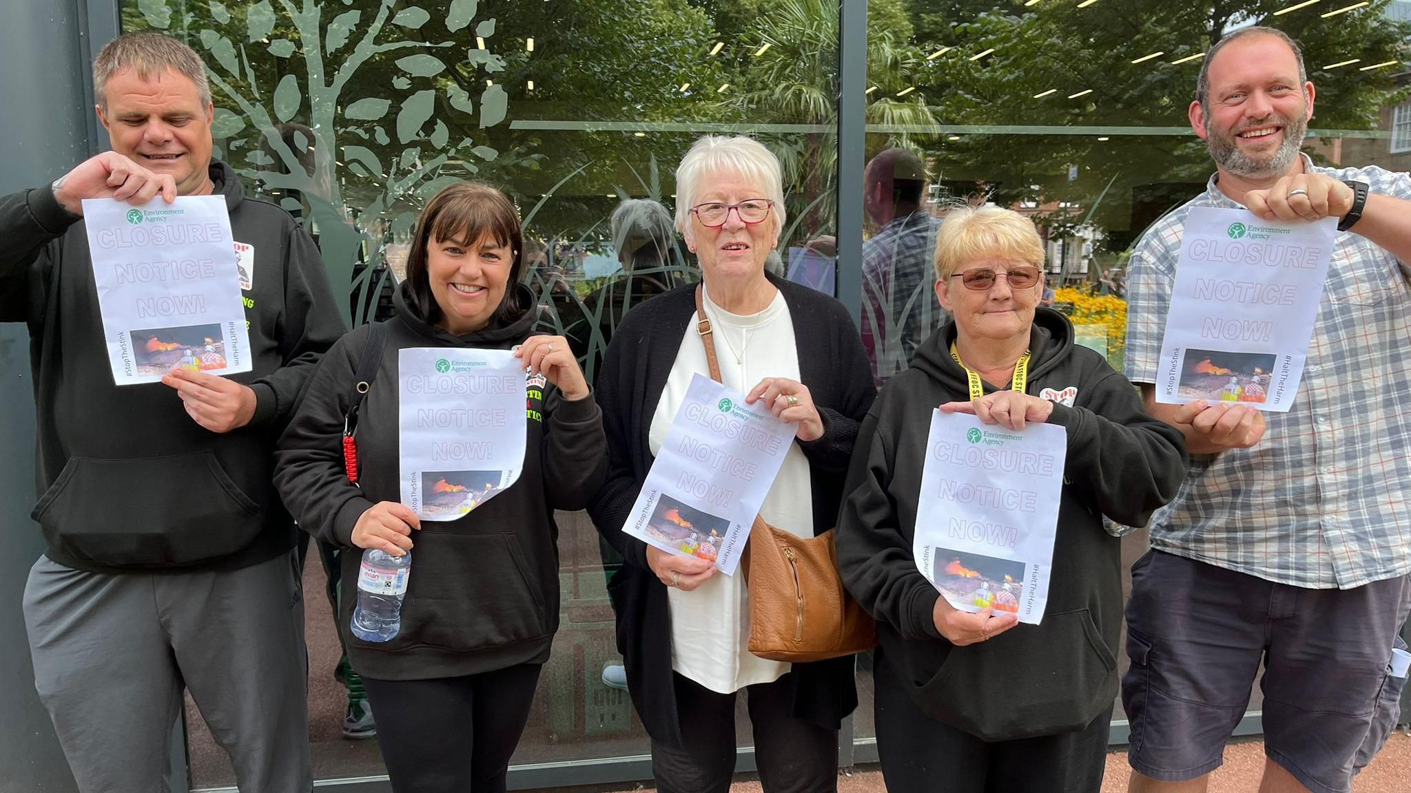 Five campaigners outside the council house ahead of an inquiry