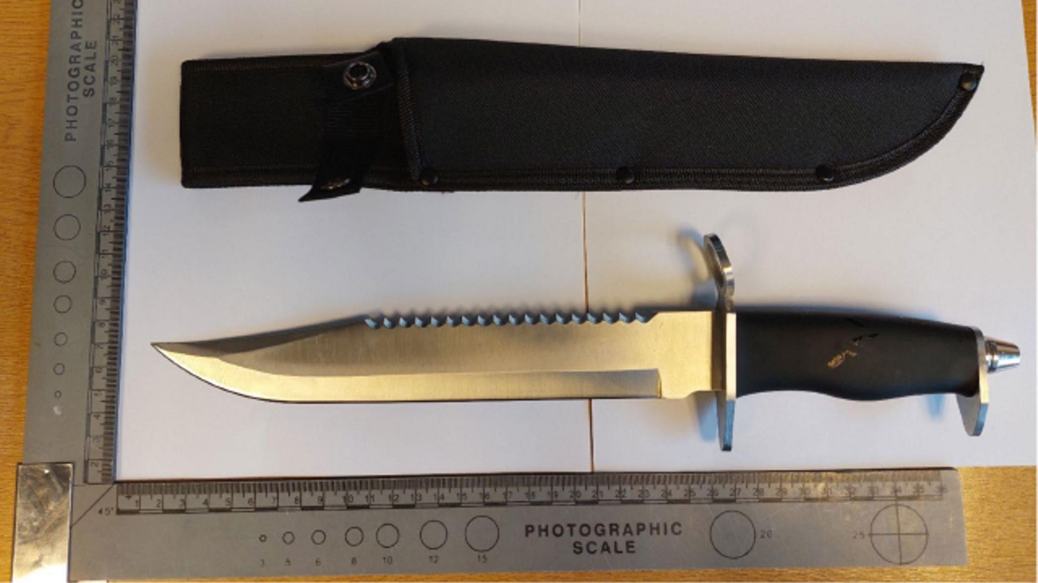 A 15in (37.5cm) hunting knife next to a black sheath