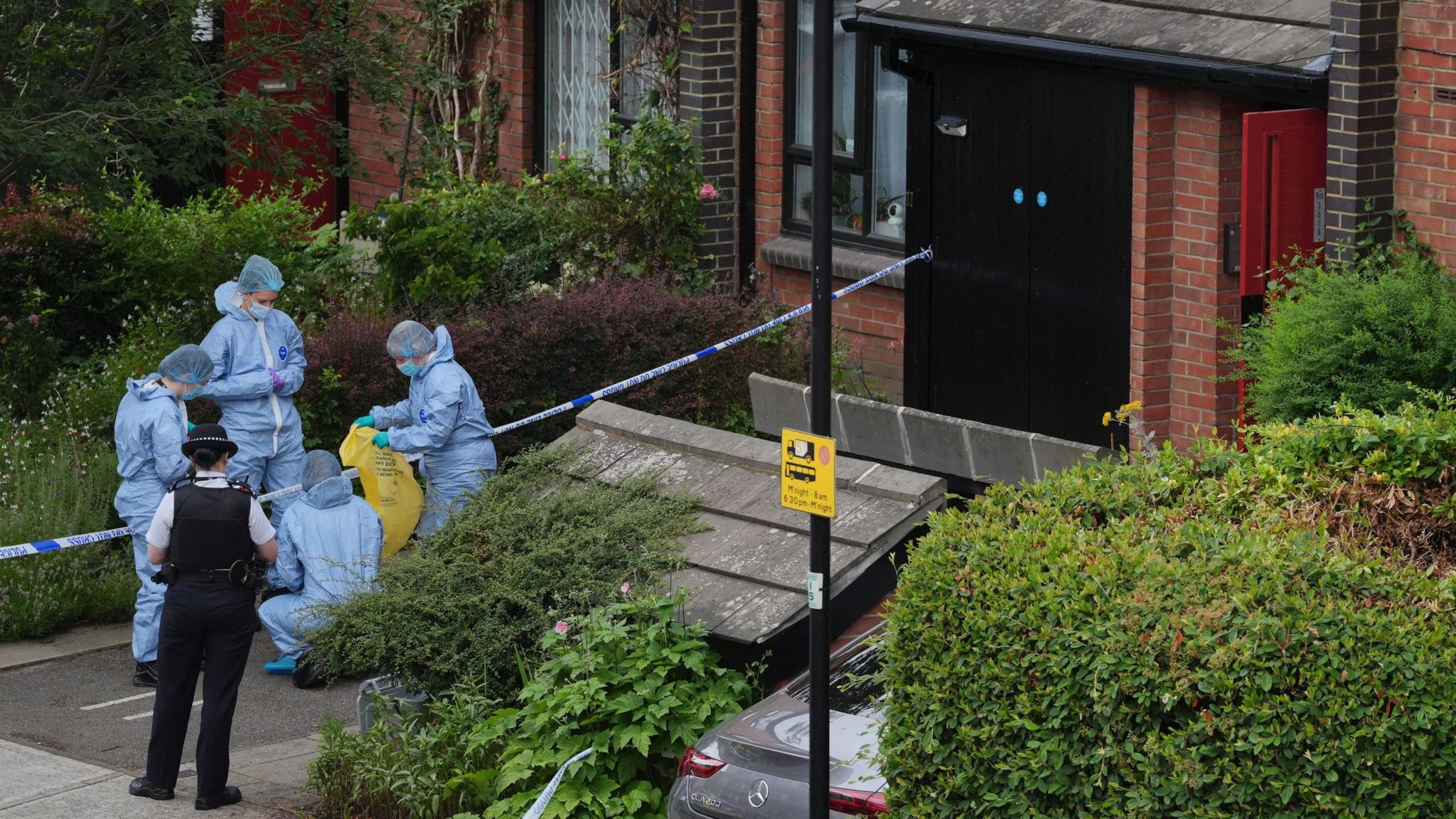 Police and forensic teams outside house being searched in Shepherd's Bush