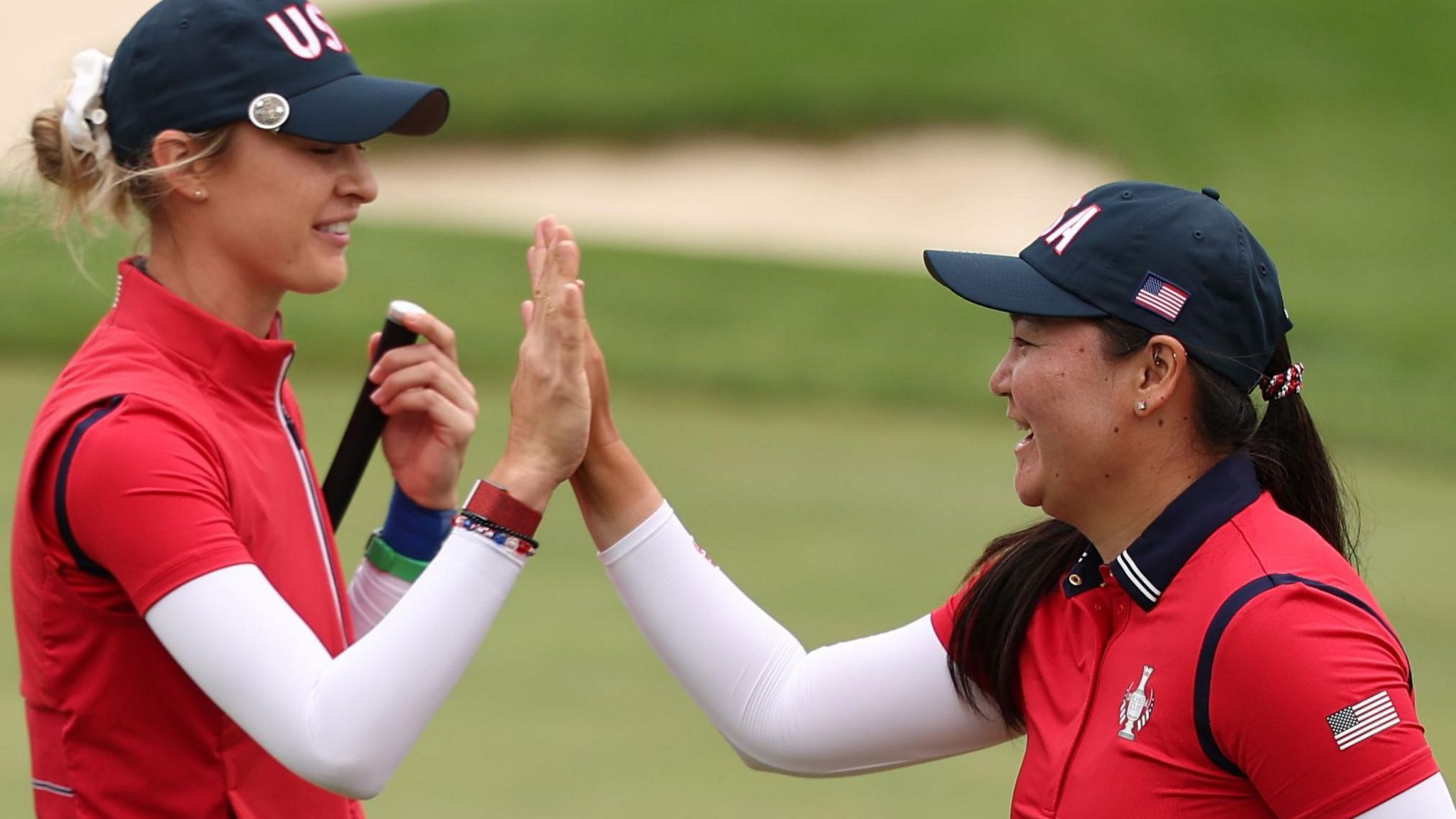 Nelly Korda and Allisen Corpuz high-five after winning their foursomes match at the Solheim Cup