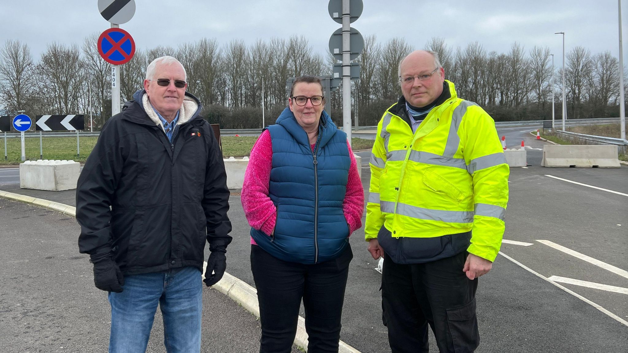 three parish councillors standing near innsworth roundabout