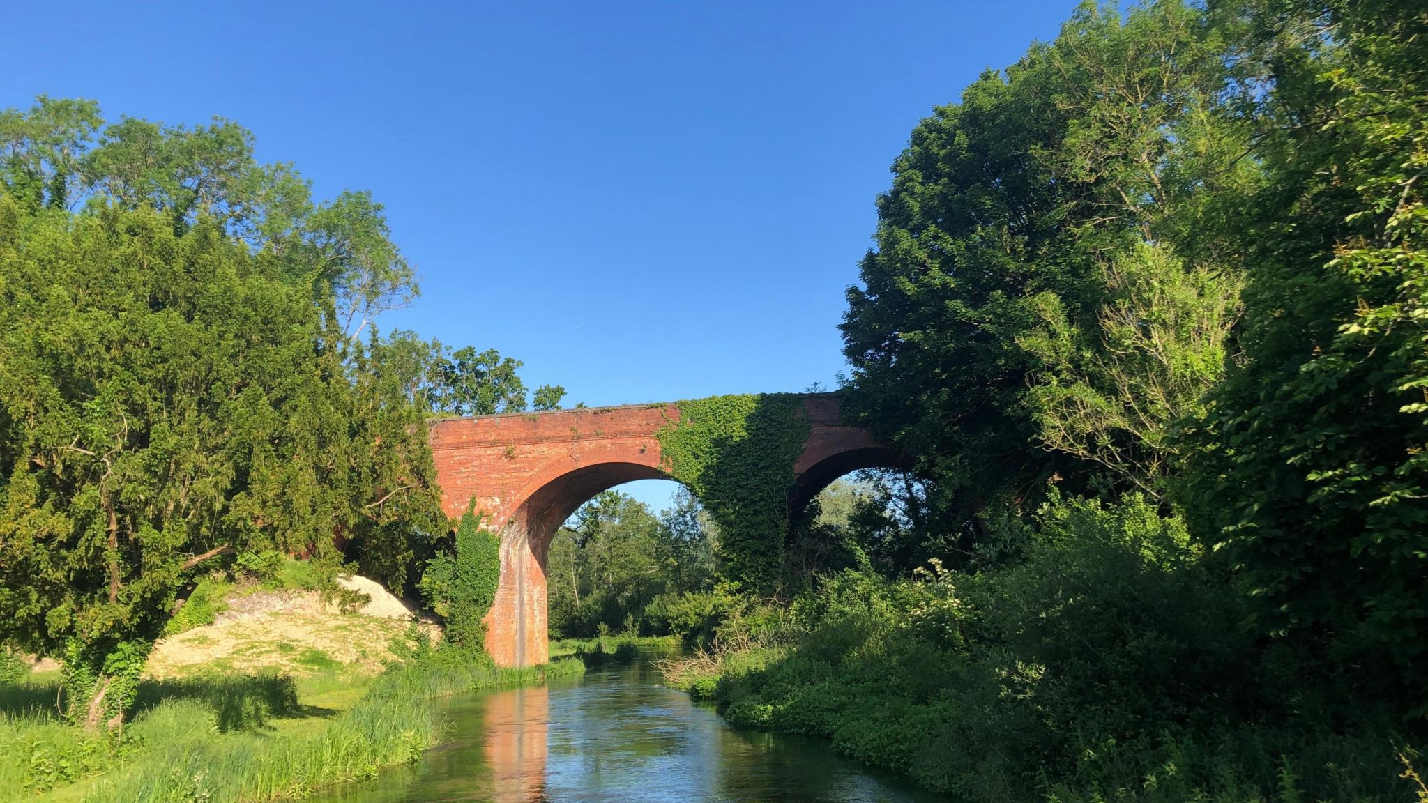 TUESDAY - A brick arch bridge over the river at Whitchurch under a blue sky