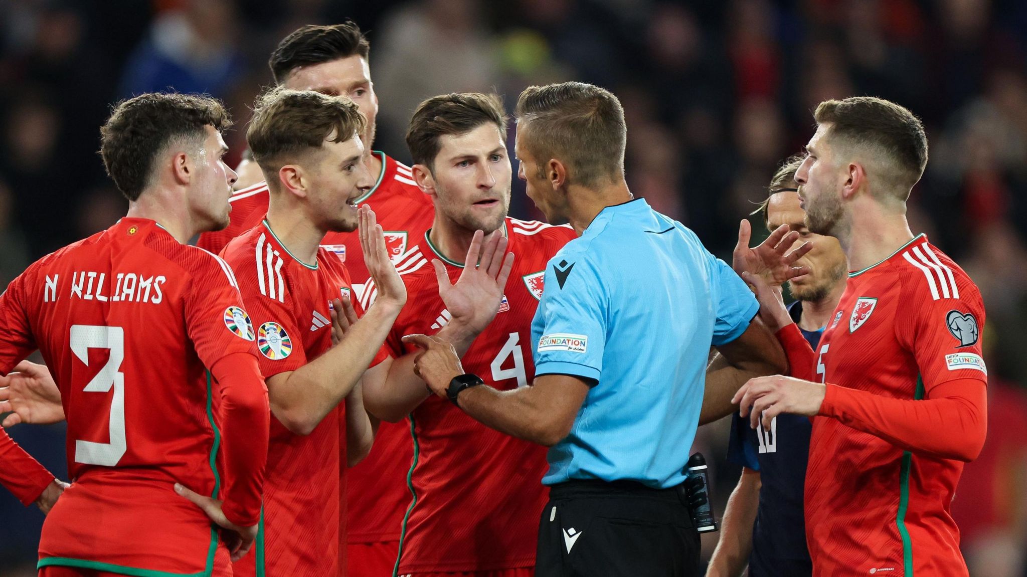 Players surrounding a referee