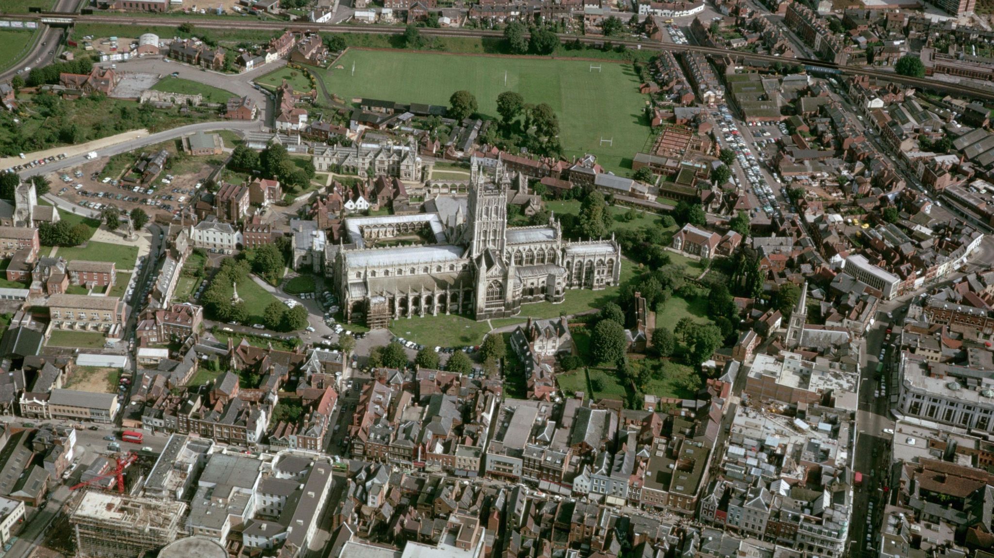 Gloucester Cathedral and surrounding streets of houses viewed from above.