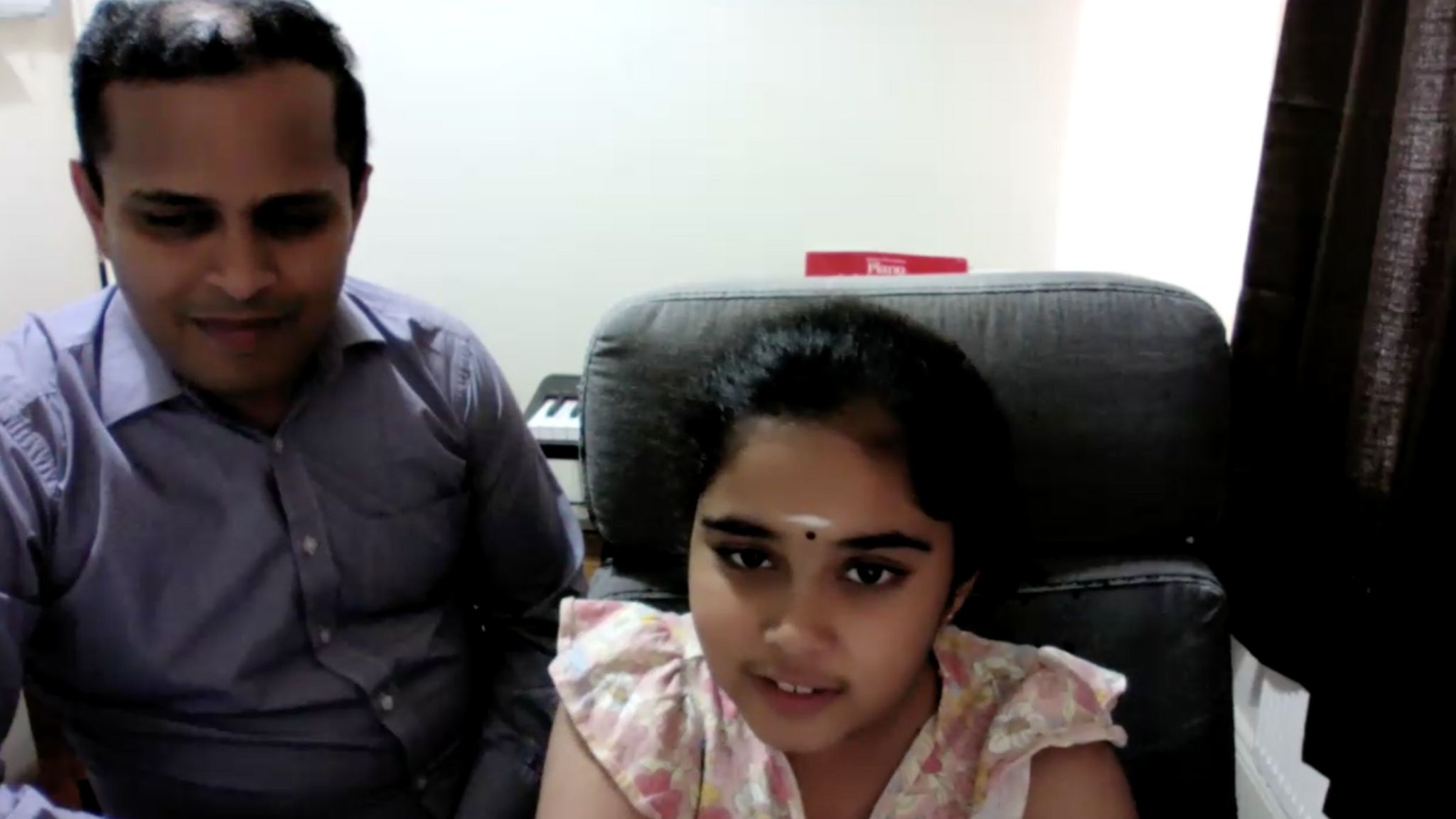 Bodhana Sivanandan with her father during a Zoom call with the BBC