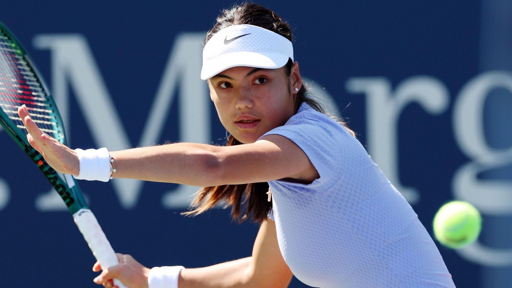 Emma Raducanu hits a forehand return in US Open practice