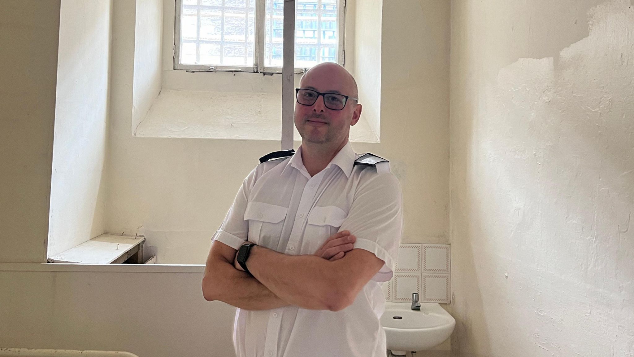 Photo of Charlie Lawson standing inside a cell at Shepton Mallet prison