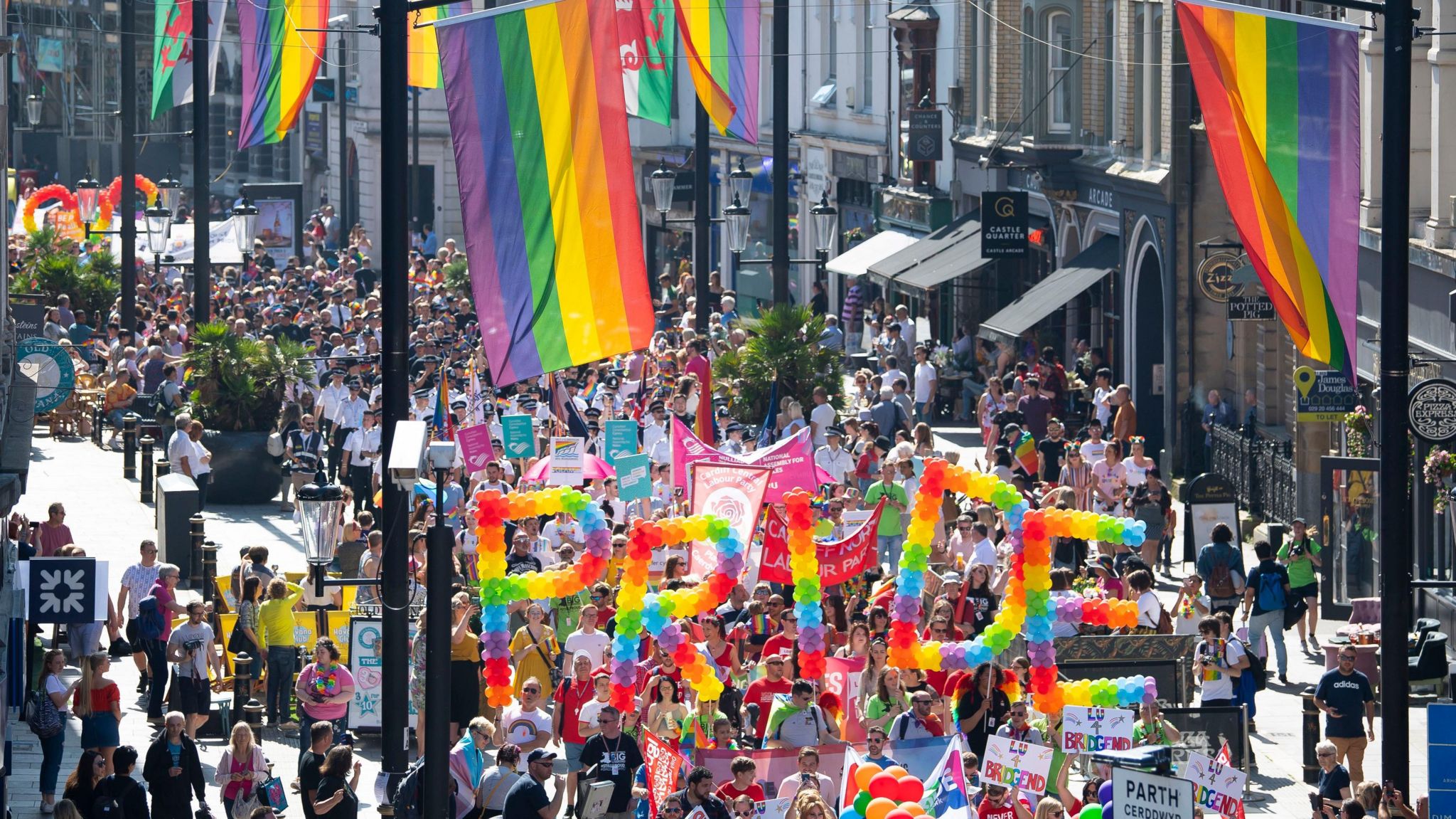Pride Cymru supporters parade through the city centre in Cardiff.