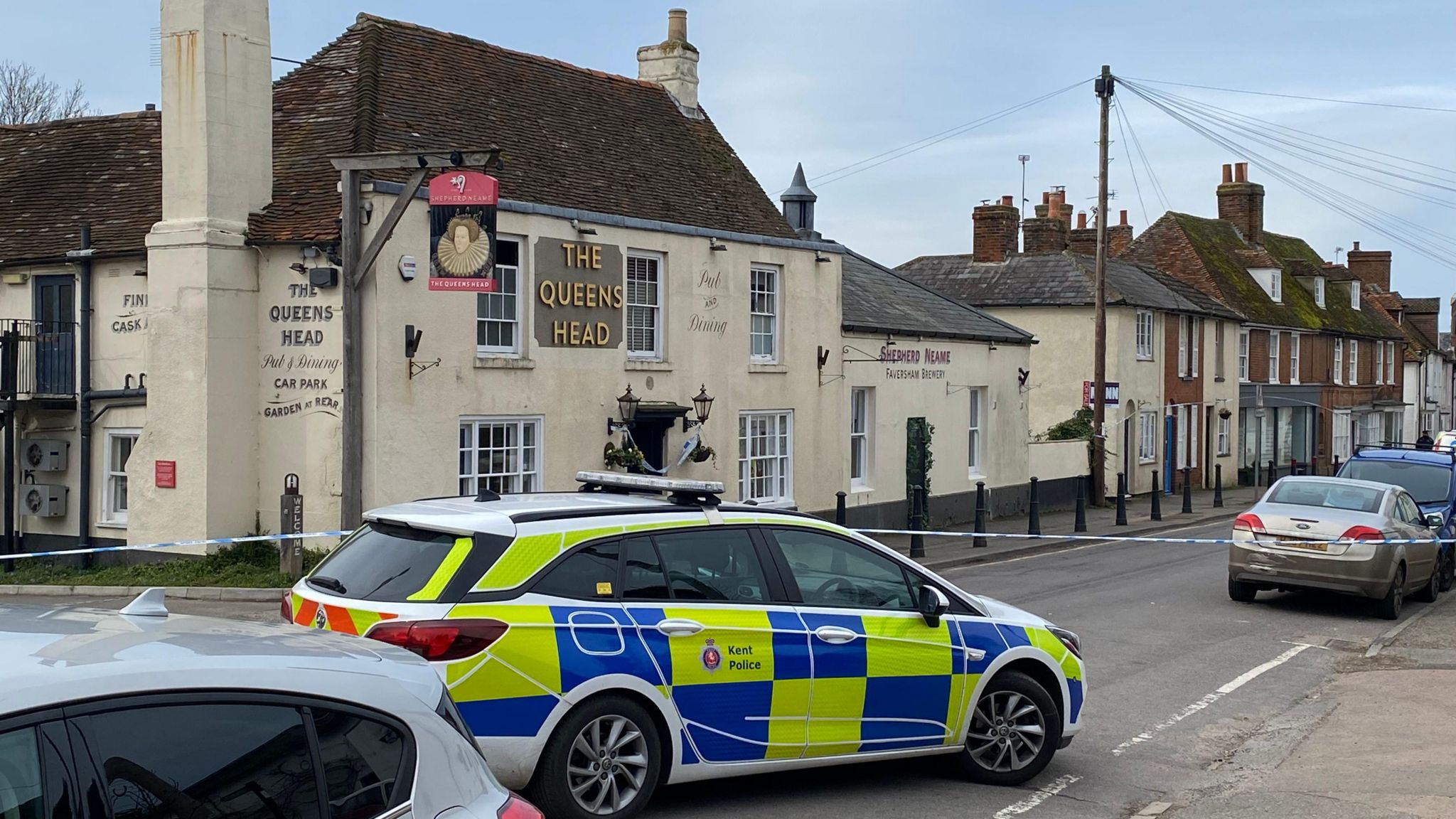 The Queen's Head pub in Boughton-under-Blean with a police car outside it