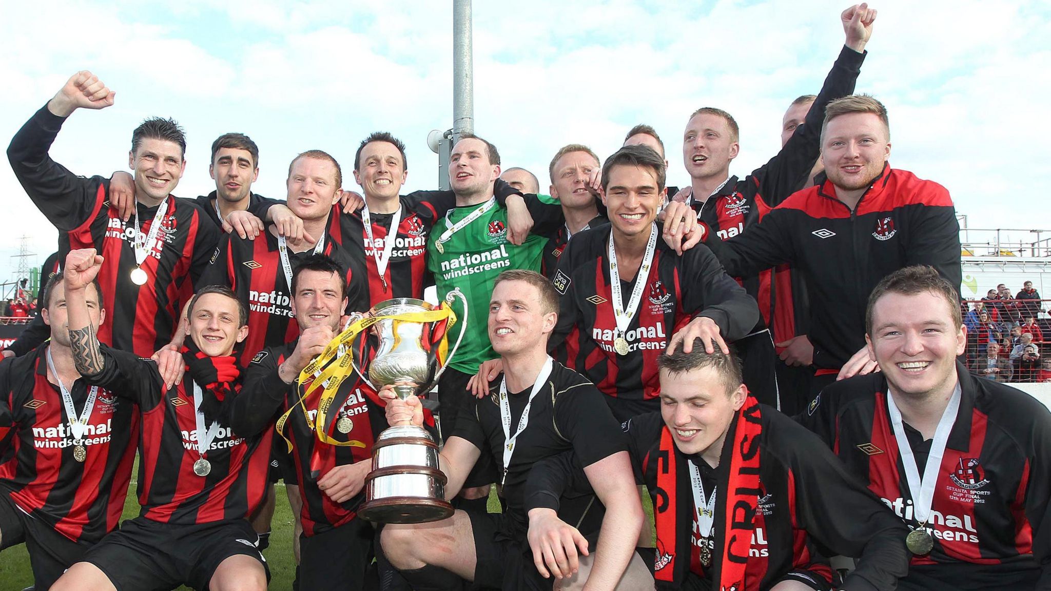 The Crusaders squad celebrate with the Setanta Cup in 2012