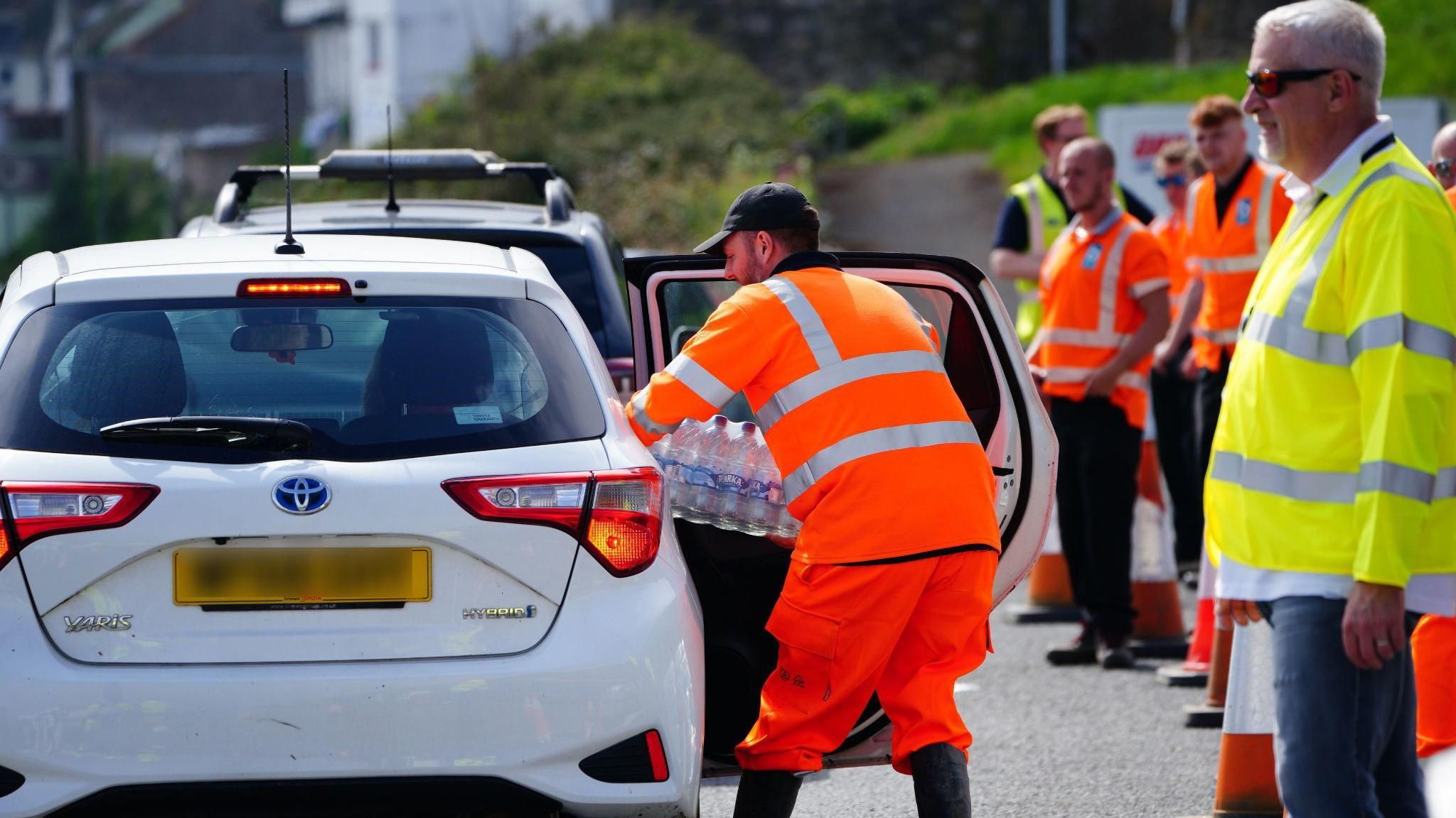 Bottled water being put in a car