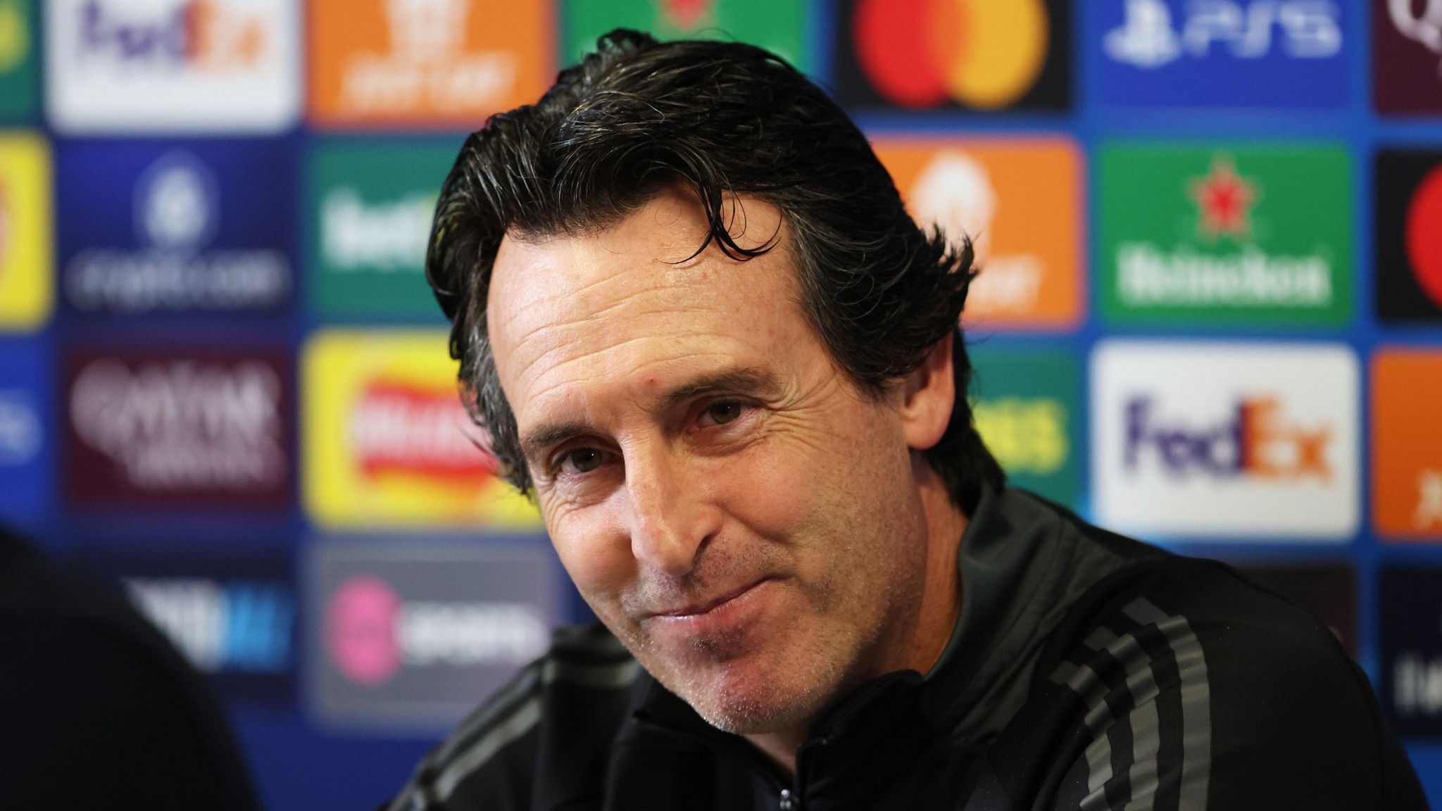 Aston Villa boss Unai Emery smiles at a news conference before their match with Bayern Munich