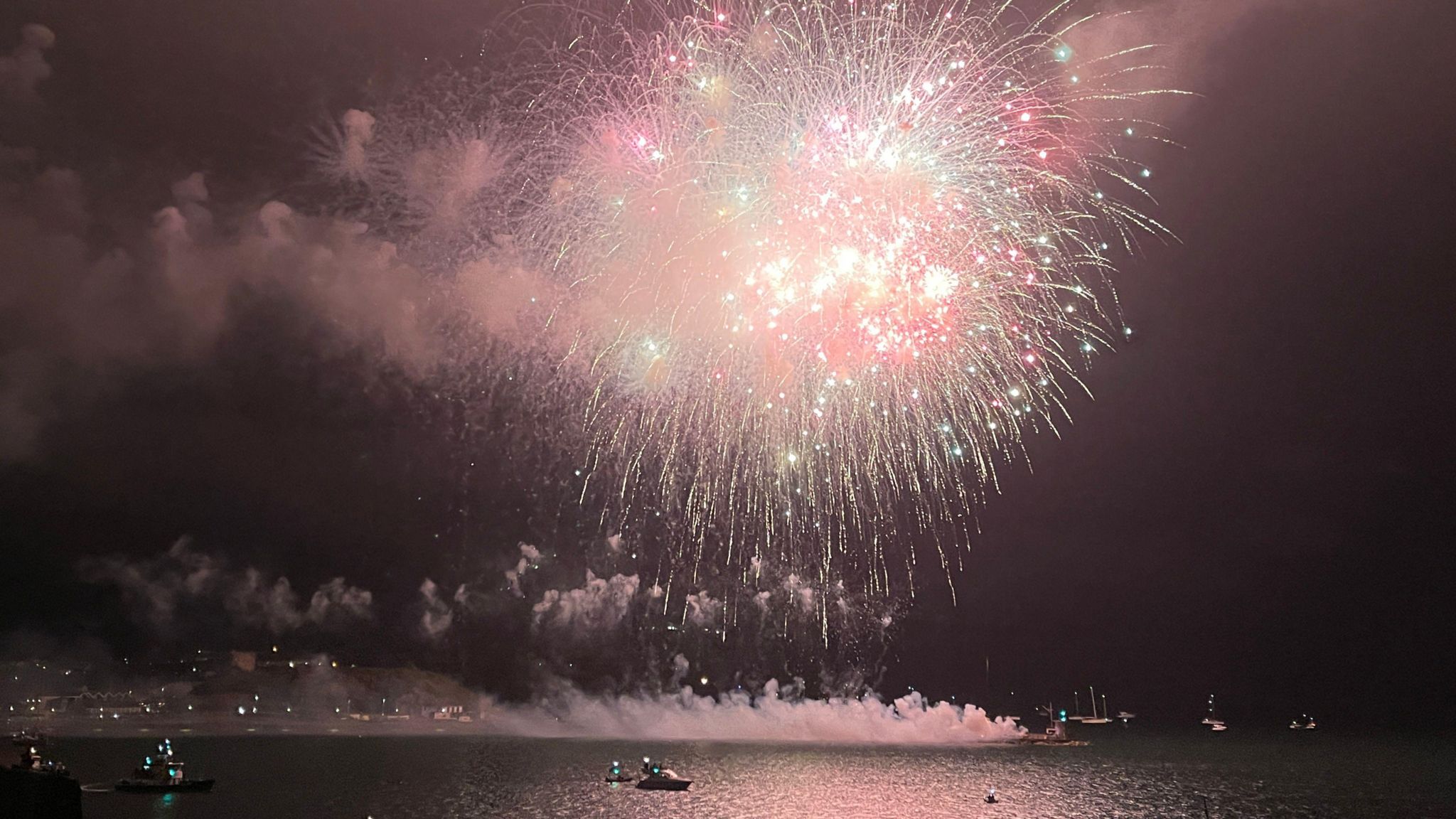 A large firework lights up the night sky over Plymouth sound