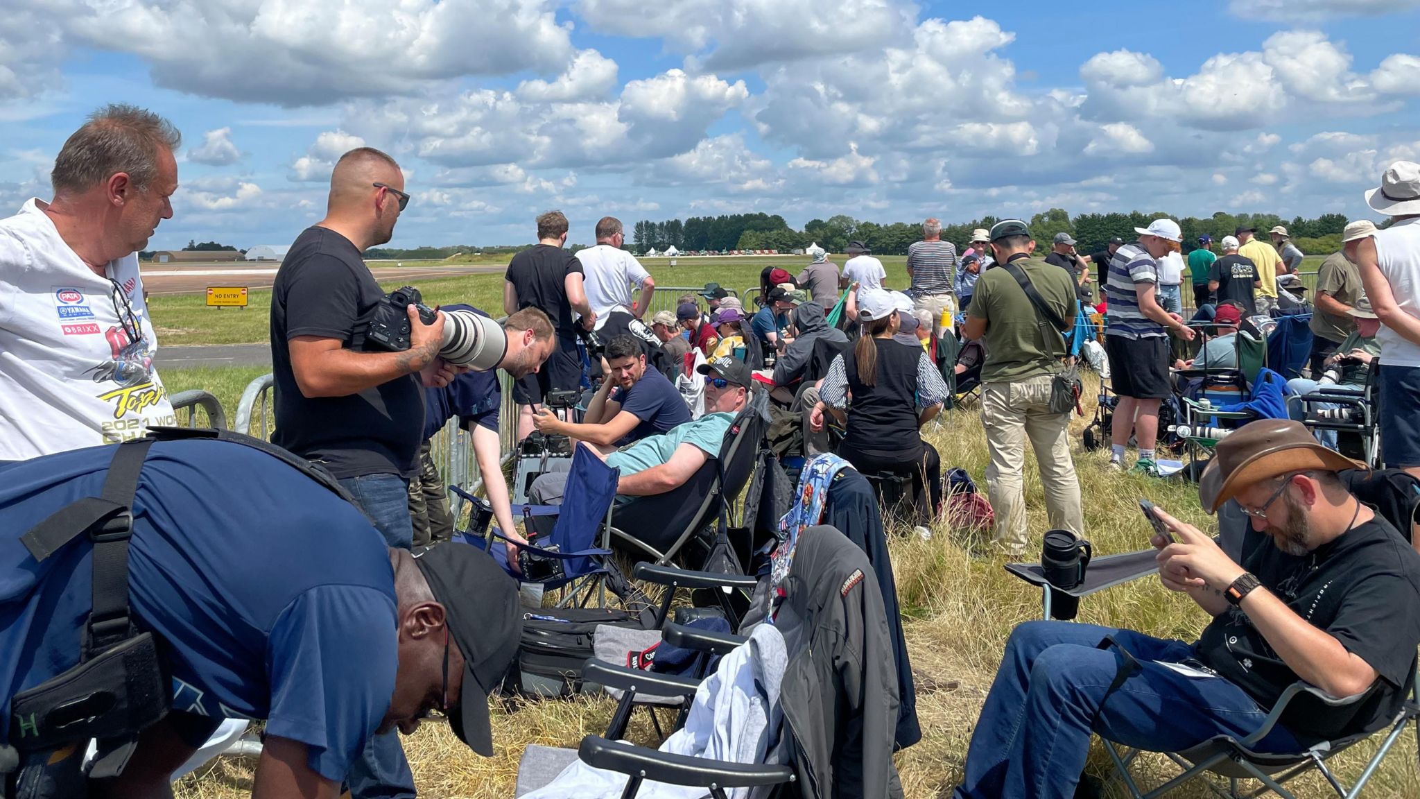 Crowds of plane enthusiasts, many with long lens cameras gathered on the edge of the runway at RAF Fairford