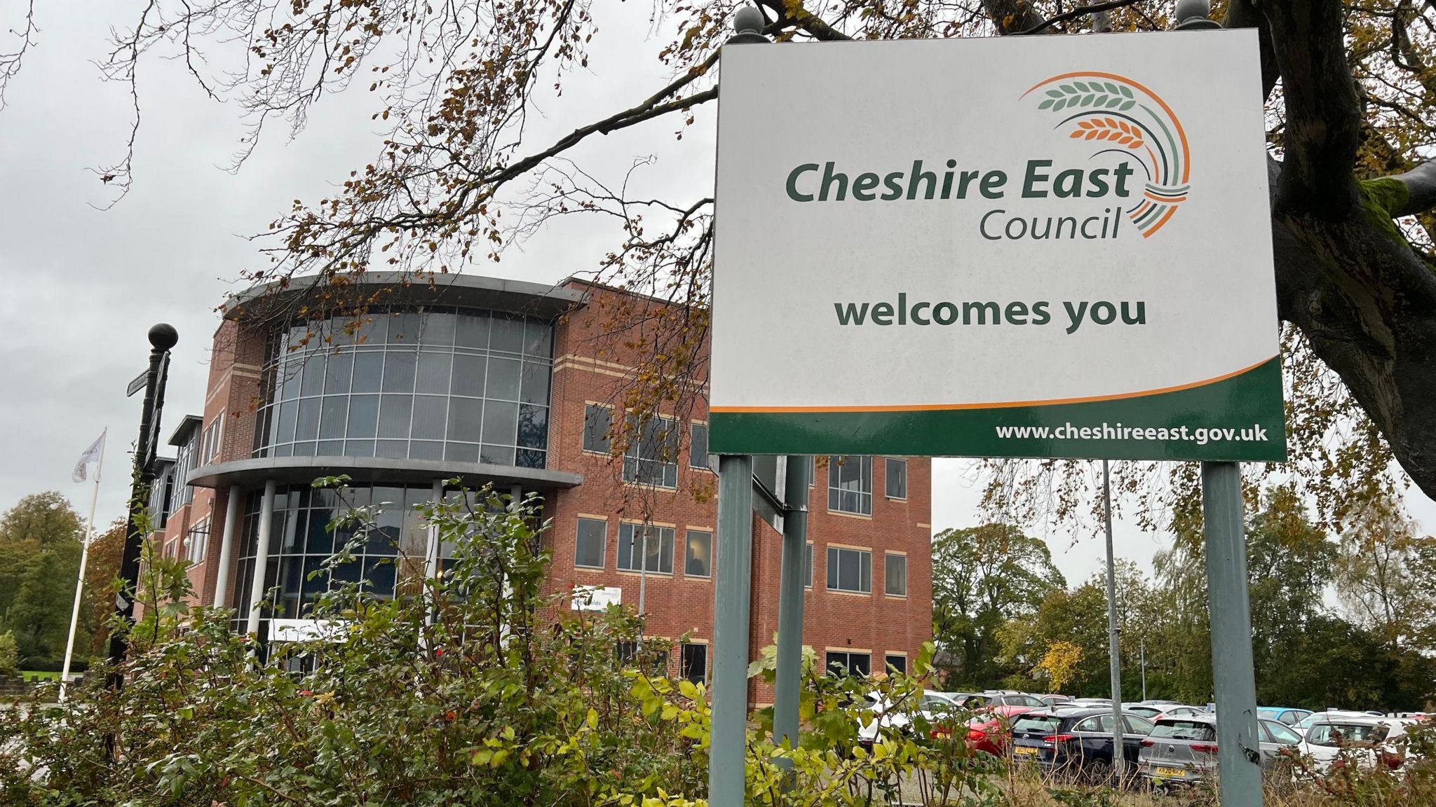 Cheshire East Council's headquarters with a sign saying Cheshire East Council welcomes you in front