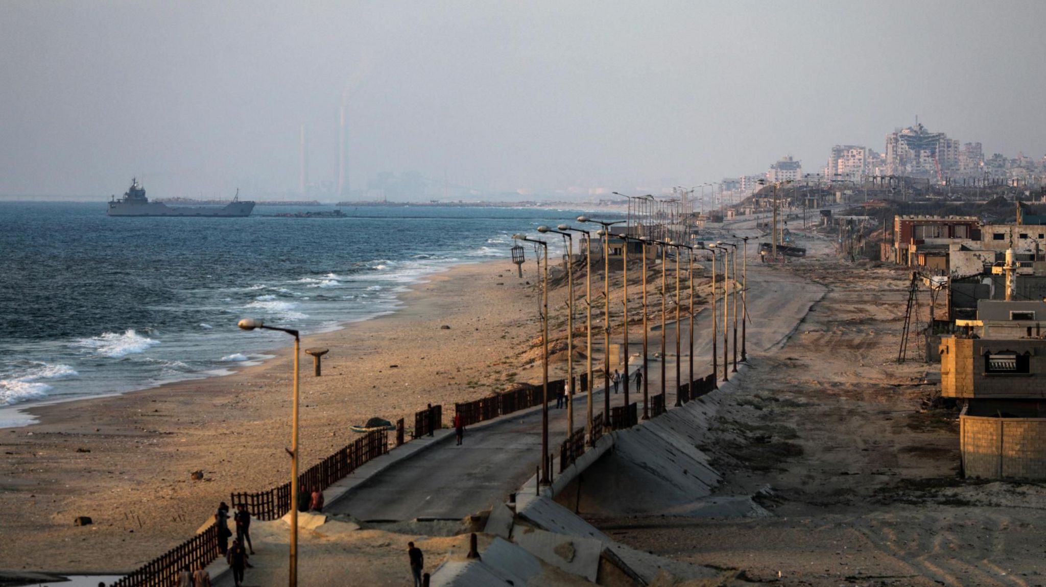 A ship is seen near a temporary floating pier, on the coast of the Gaza Strip  (27 June 2024)