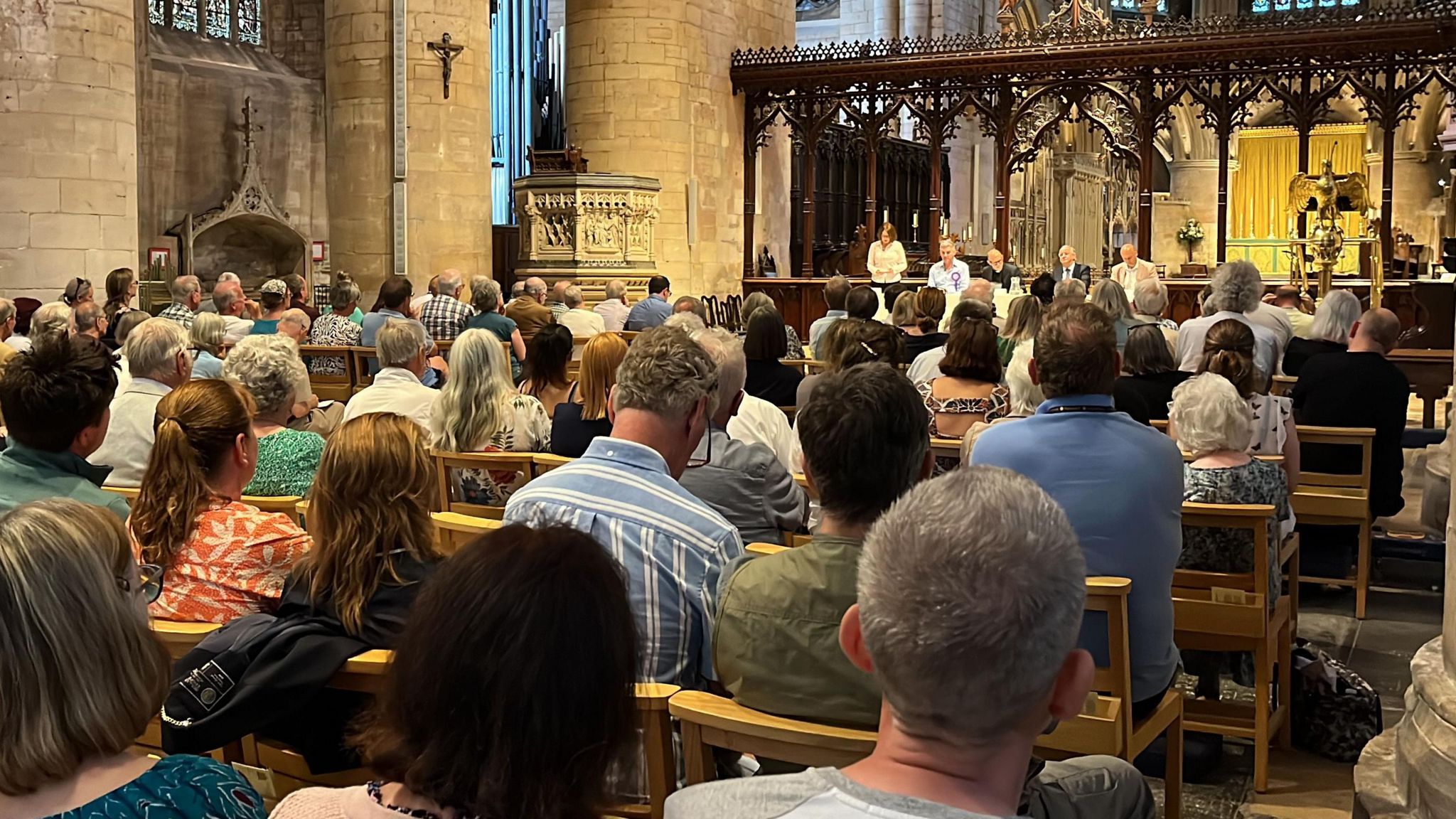 The hustings audience inside Tewkesbury Abbey looking towards the four parliamentary candidates Cate Cody, Laurence Robertson, David Edgar and Cameron Thomas.
