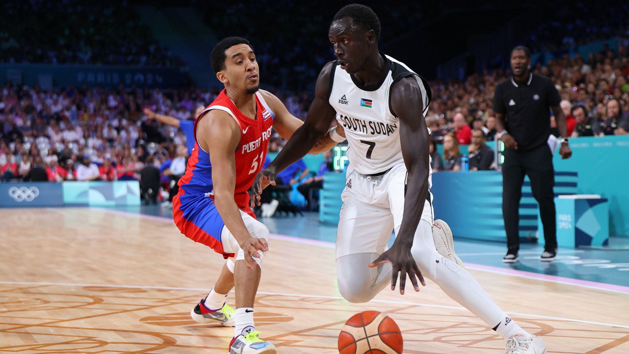 Bul Kuol dribbles against Tremont Waters of Puerto Rico