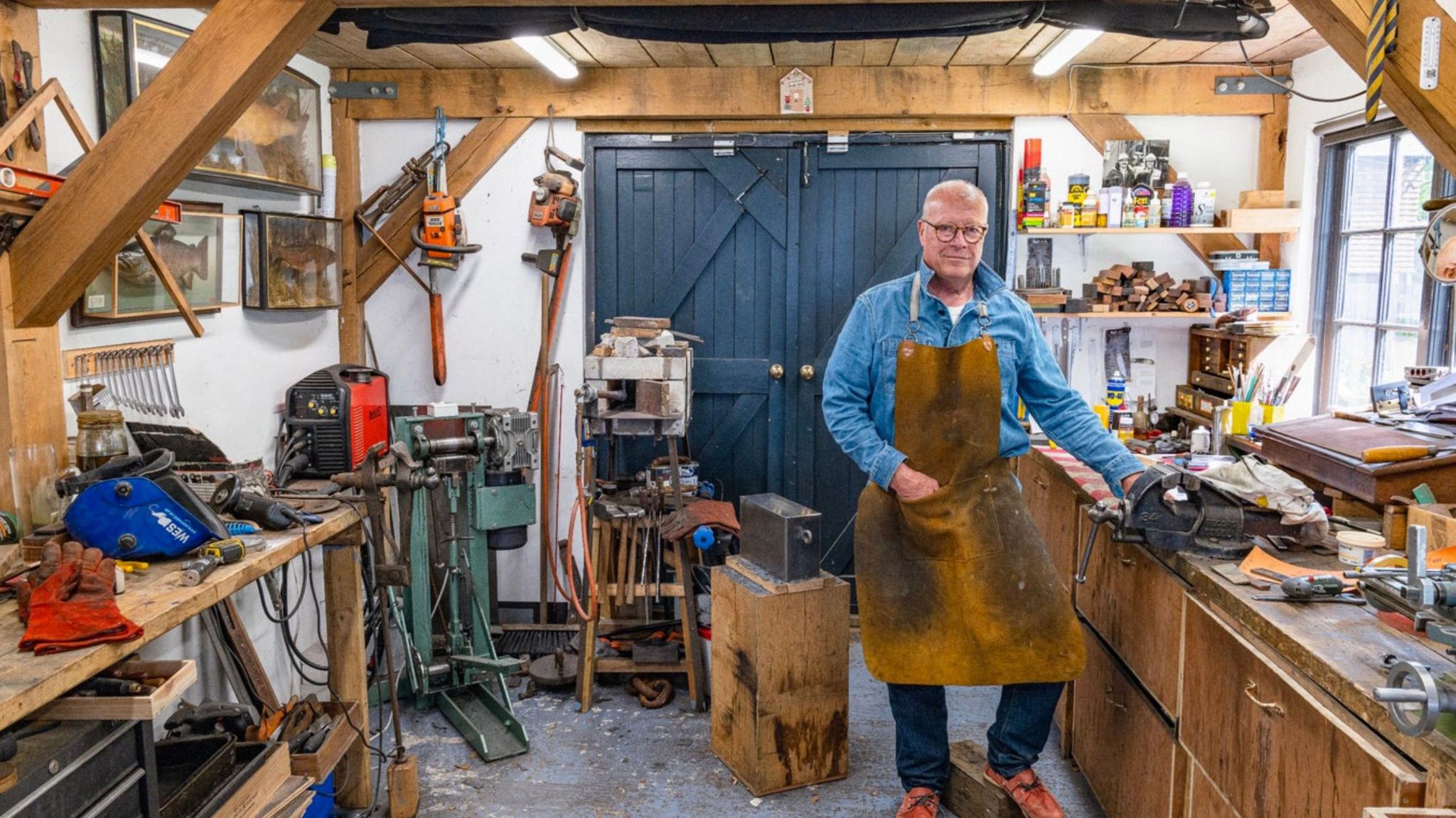 Clive Witton standing in his workshop.