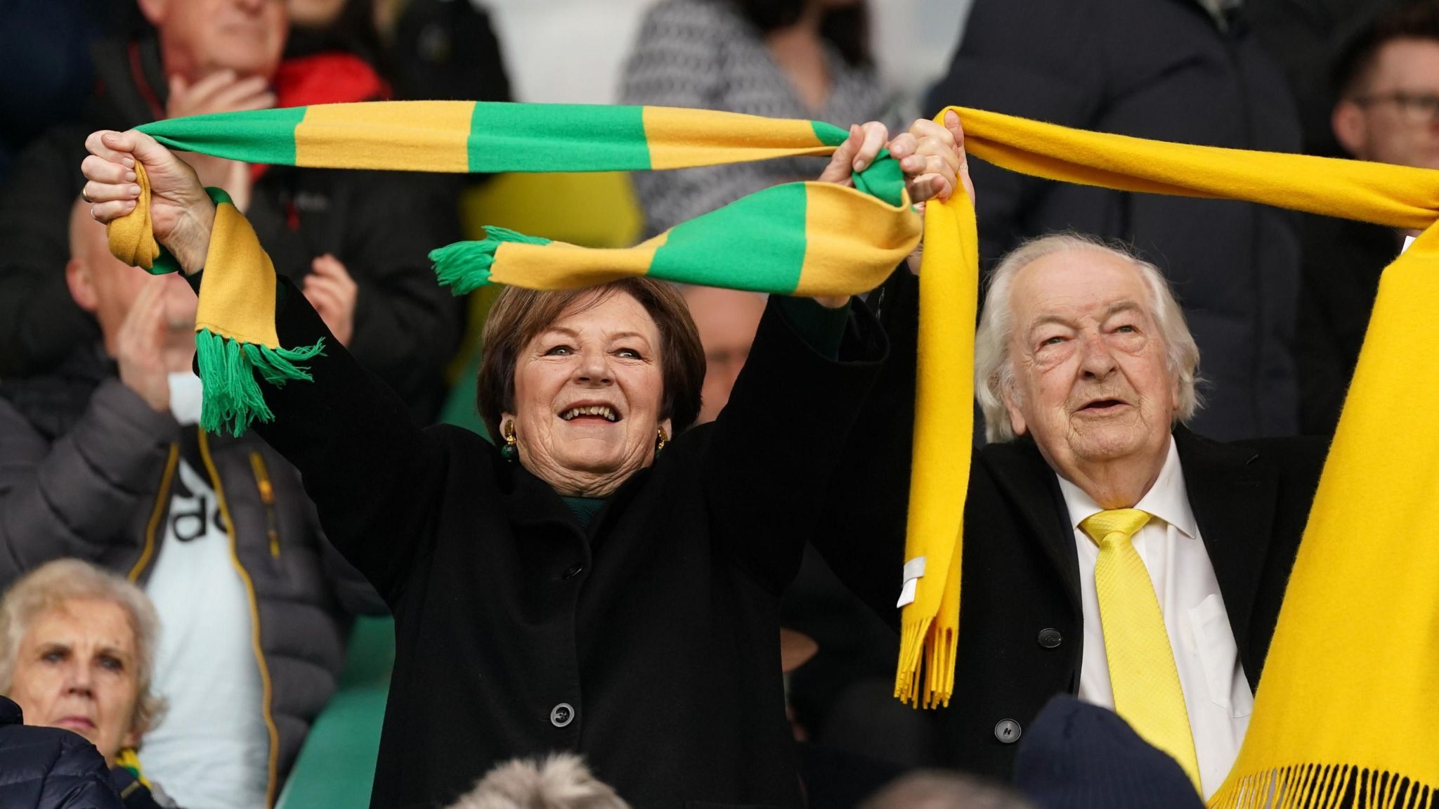 Delia Smith and Michael Wynn Jones with Norwich City Football Club scarfs