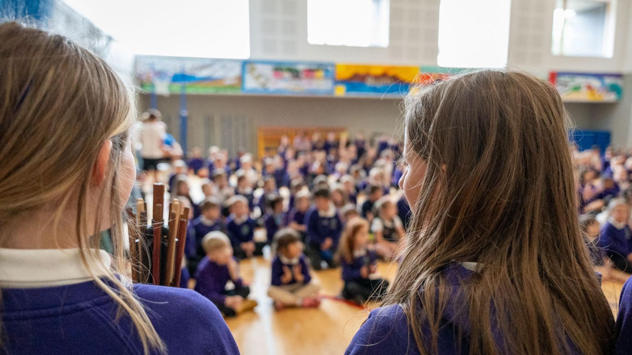 Pupils in purple uniforms sat in assembly