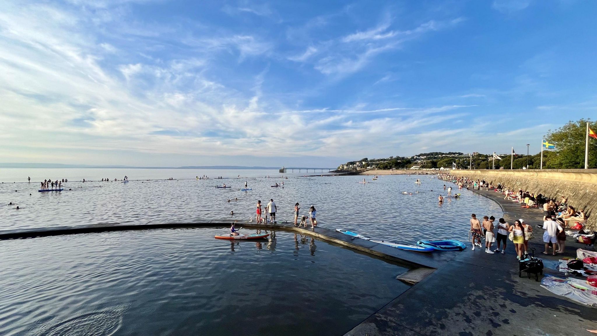 Clevedon Marine Lake. People can be seen hanging in and around the water. 