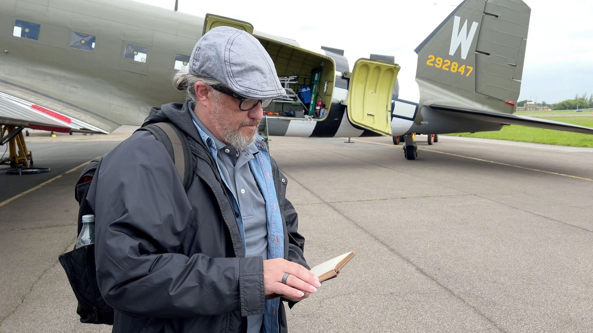 Al Reams grandson thumbs through the pilot's wartime diary