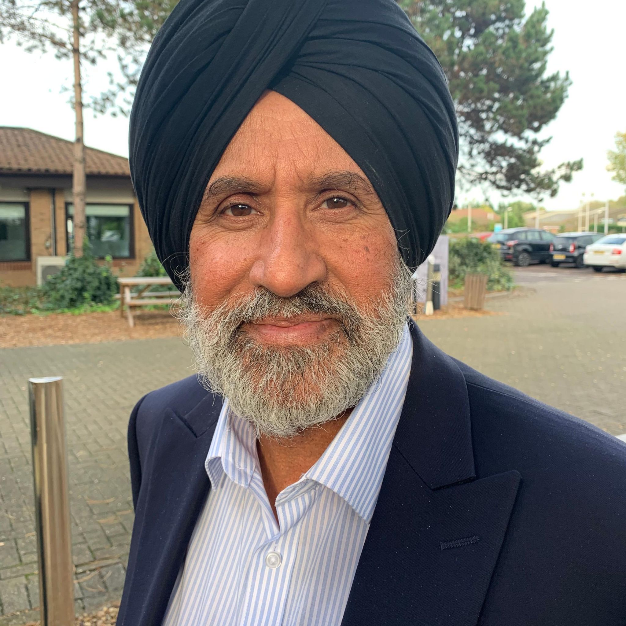 Liberal Democrat Candidate Jasbir Singh Parmar with a blue jacket and a white striped shirt