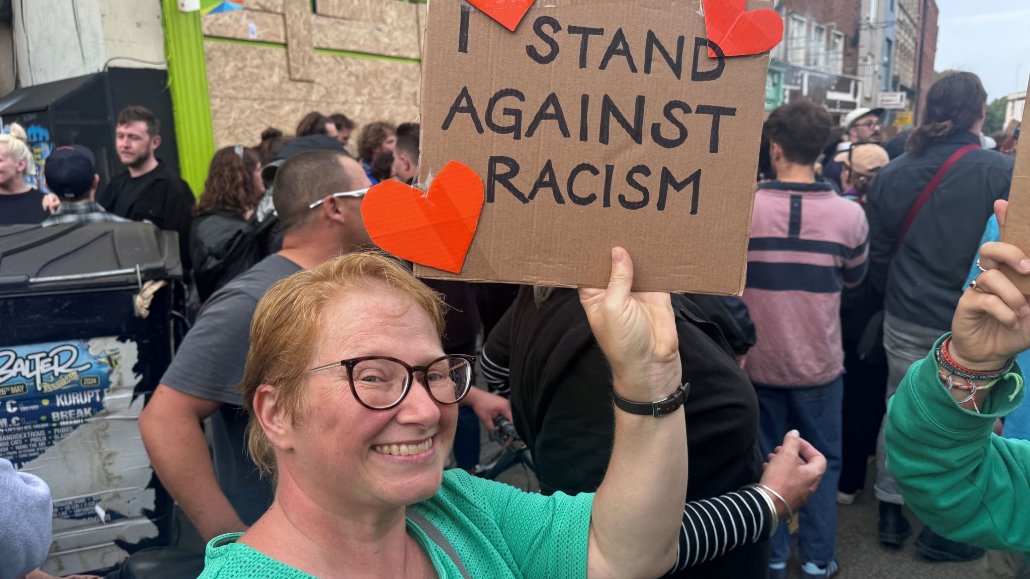 A counter-protester stands against racism in Bristol