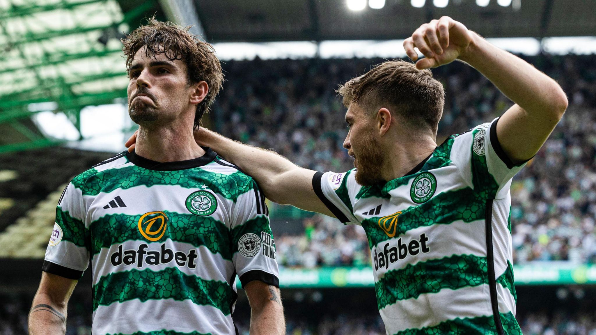 Matt O'Riley and James Forrest celebrate taking the lead against Rangers