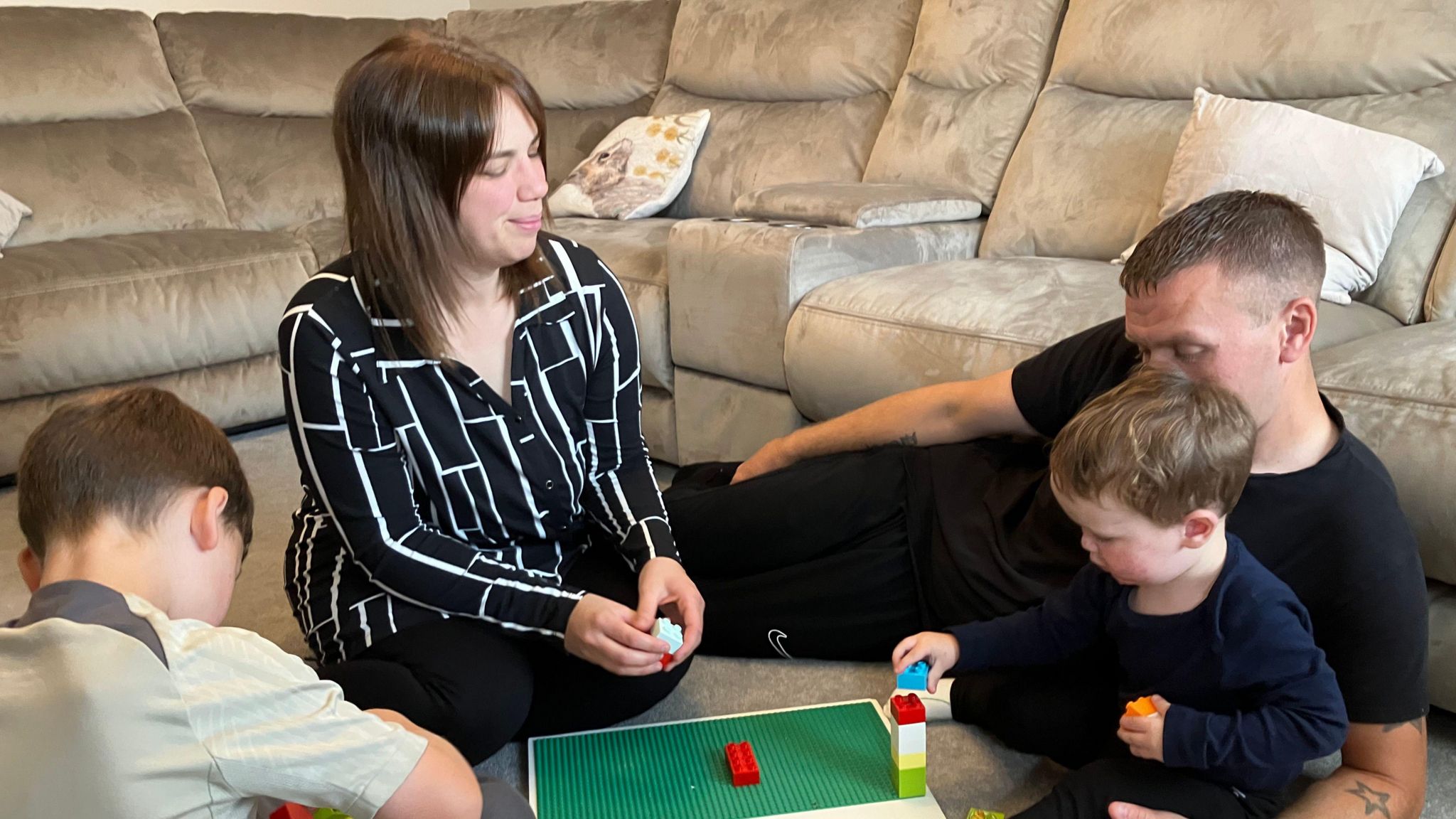 Leo playing with his parents and brother