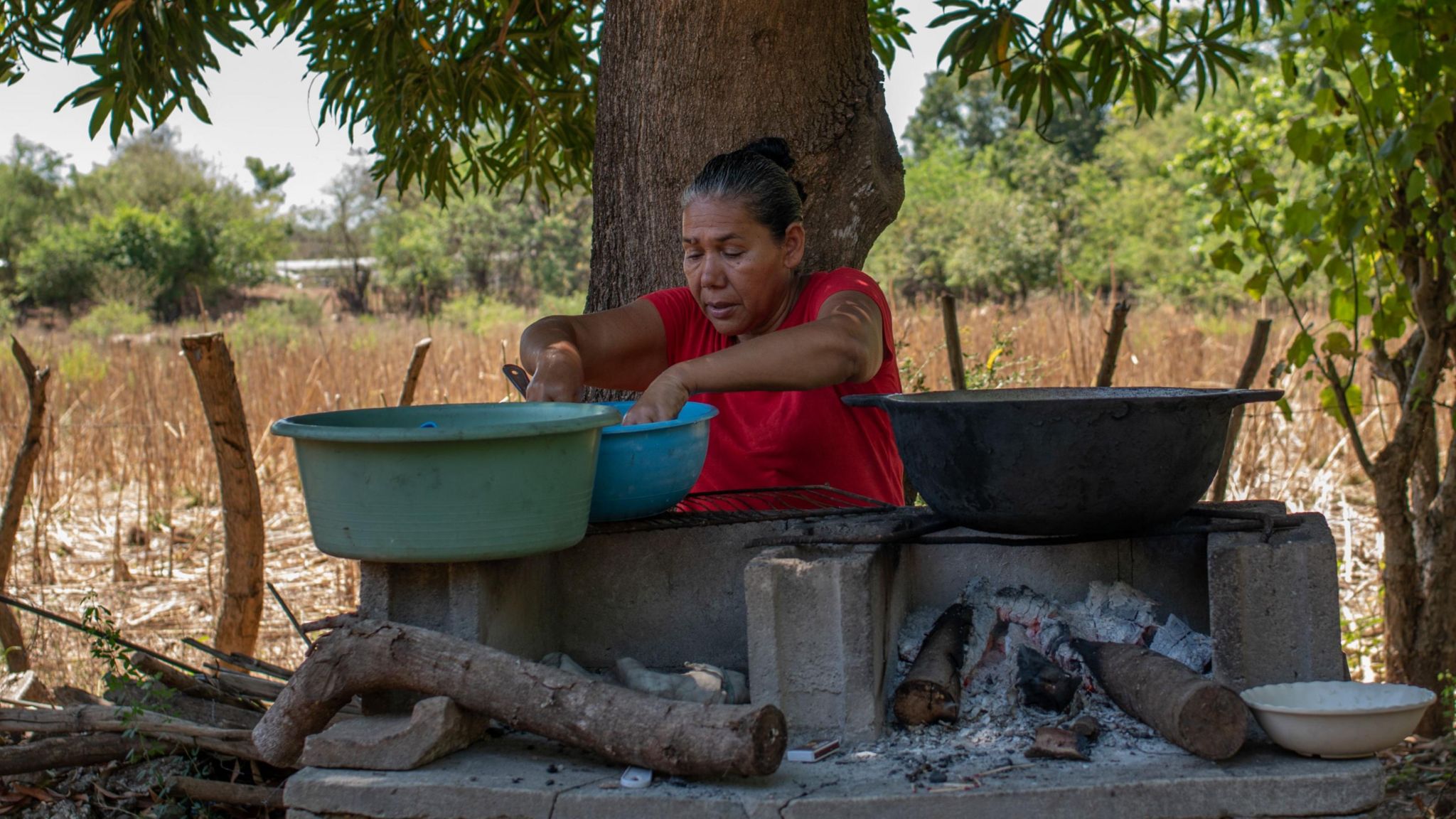 Marcela Alvarado prepares food outside her house