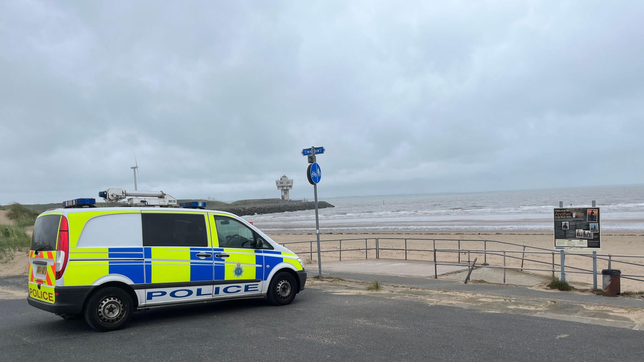 Police van parked at beach as emergency services search for missing teenager 