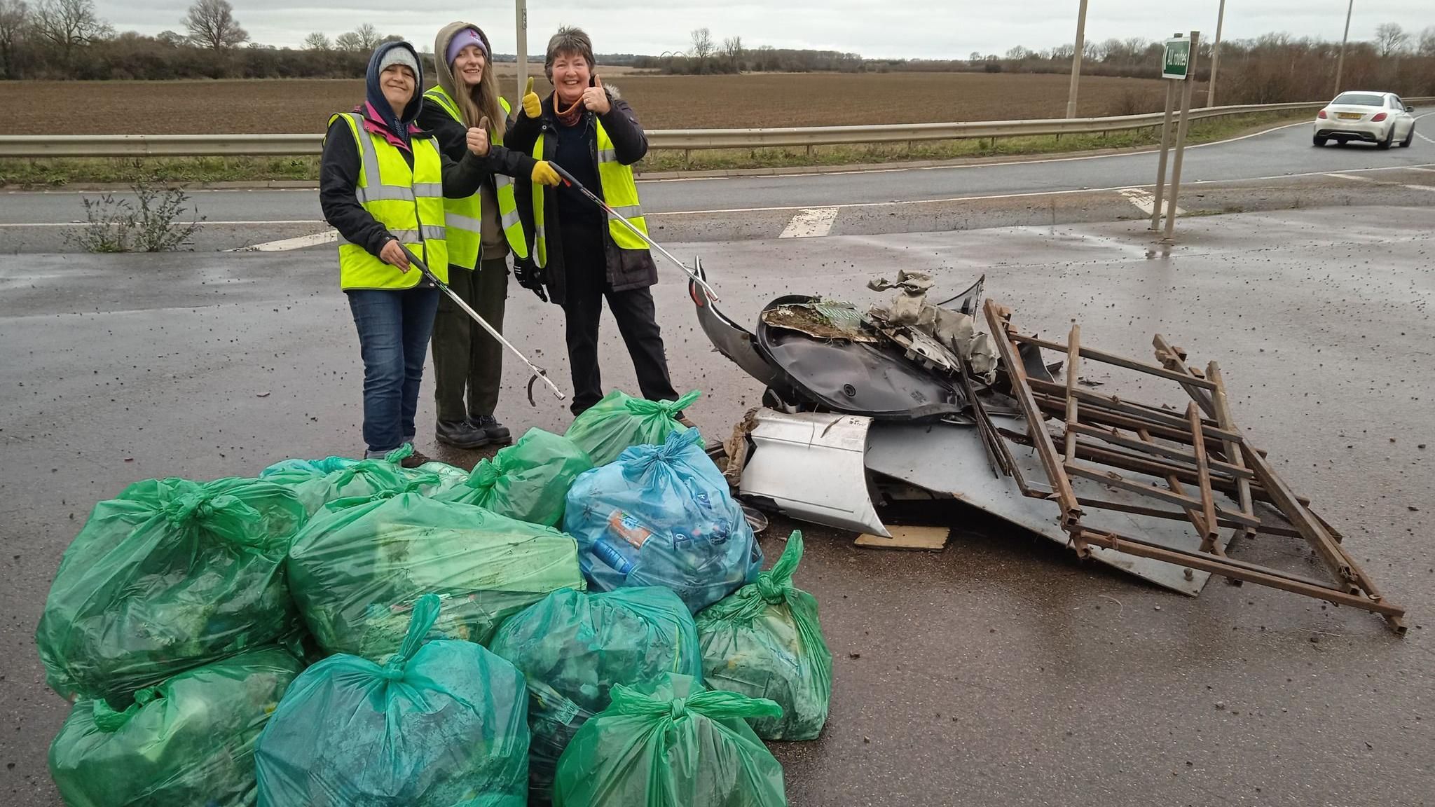 Litter picking group with bags of rubbish on the A47