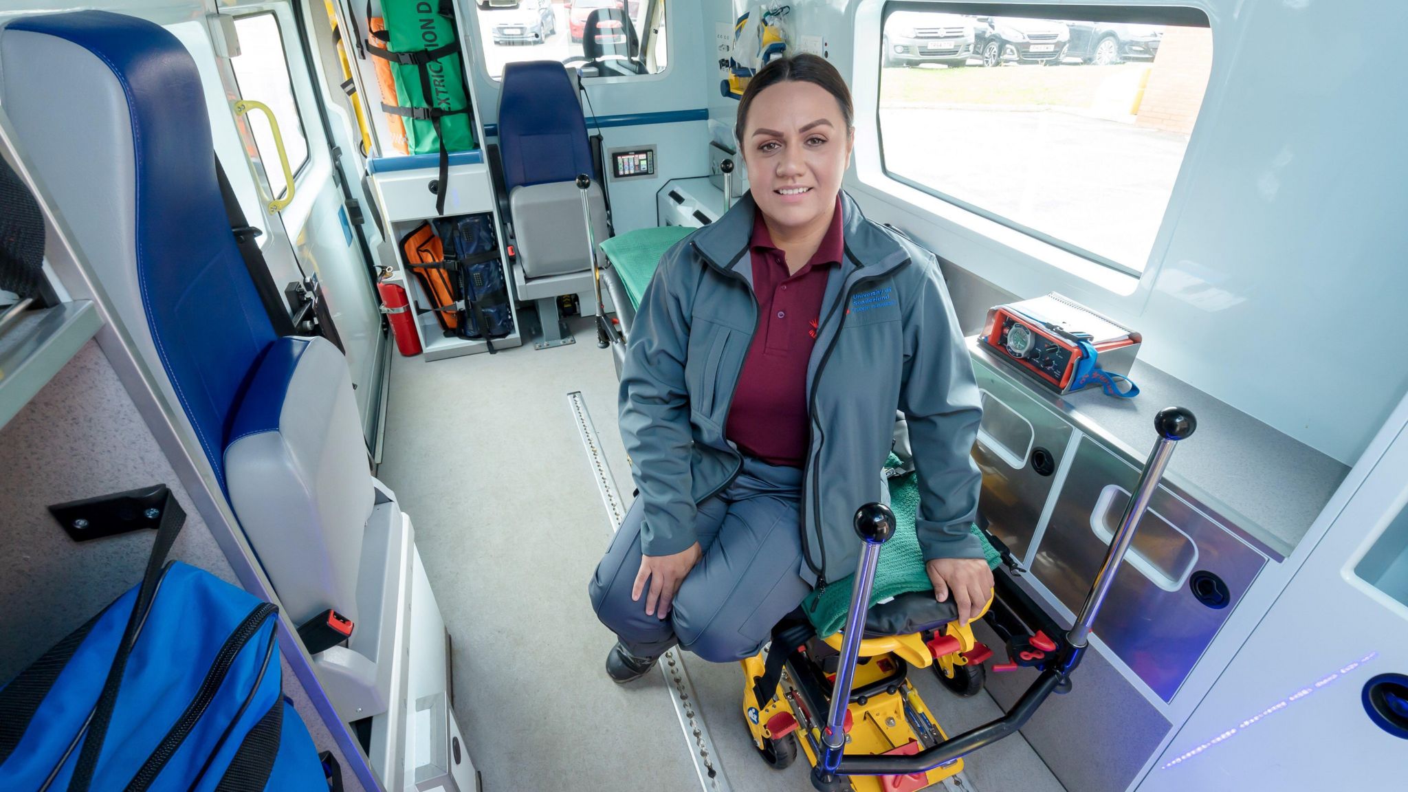 Stacey Thain posing inside an ambulance