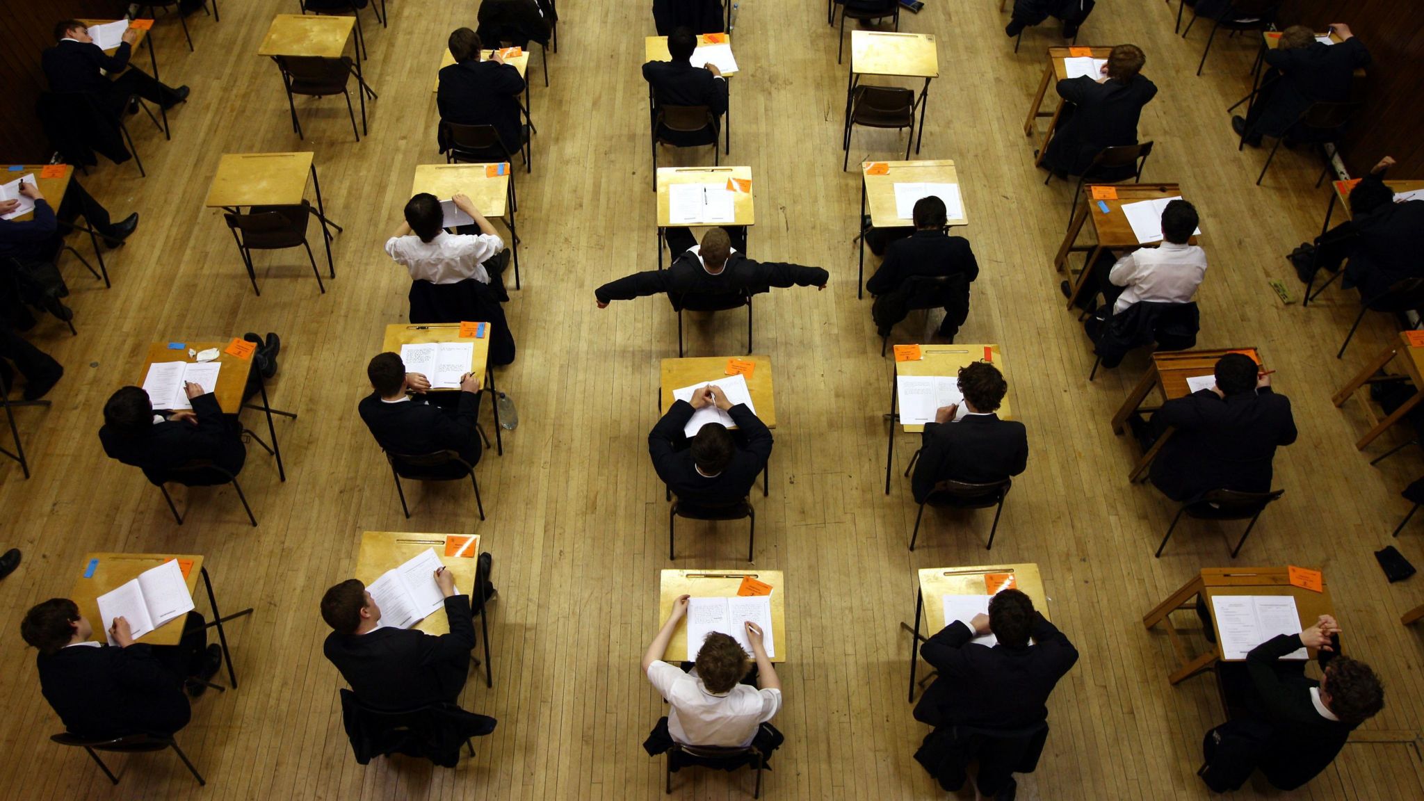 Aerial shot of rows of students taking an exam