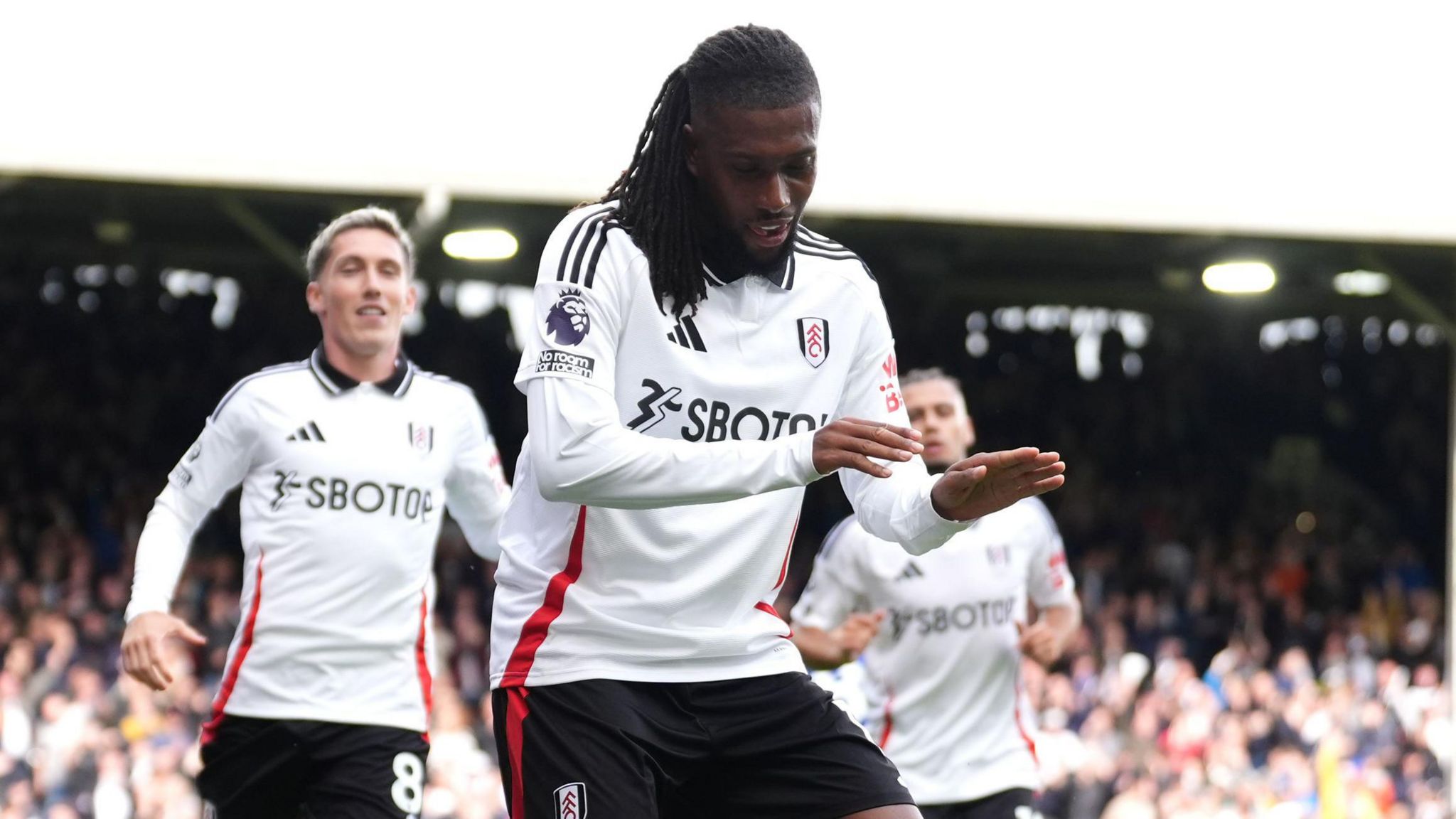 Fulham's Alex Iwobi (centre) celebrates scoring his side's second goal against Leicester at Craven Cottage