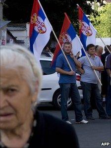 Serbs stand with flags in the Serbian part of Mitrovica, Kosovo, 22 July