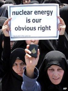 A woman holds up a Koran during a protest in support of Iran's nuclear programme just outside Isfahan, south of Tehran, 16 August 2005