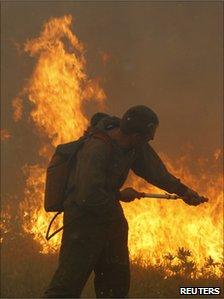 A firefighter battles flames outside Shatura, a town 110km (68 miles) south-east of Moscow, 12 August