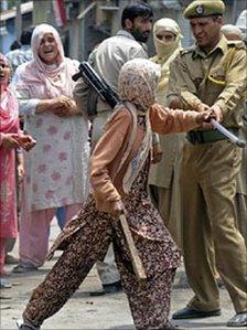 A Kashmiri woman engaged in a scuffle with security forces