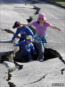 Children play in a damaged road in Christchurch (6 September 2010)