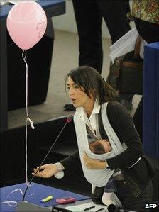 Italian MEP Licia Ronzulli, with her baby, speaks during the debate on maternity leave in Strasbourg