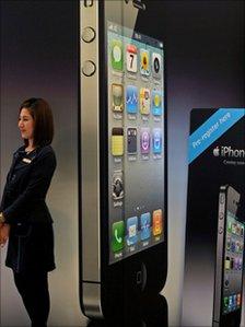 Woman stands by giant iPhone