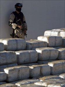 Mexican soldier stands guard by the packets of seized marijuana in Tijuana on 3 November