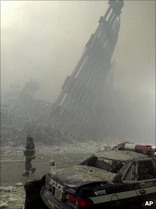 A firefighter stands among the remains of the World Trade Center