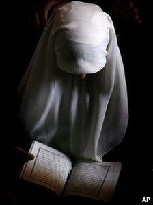 A Muslim woman reads the Koran