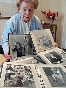 Jean Alexander looking at photos of her time in Coronation Street