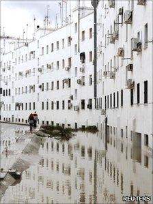 Two people walk along a flooded street in the town of Ecija, southern Spain