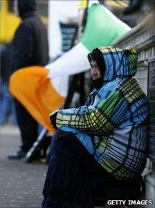 A woman begs for money in Dublin
